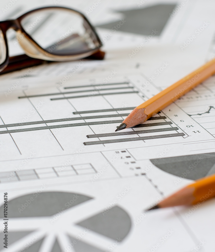 Business analytics, graphs and charts. A schematic drawing on paper. Two pencil Business analytics, graphs and charts. A schematic drawing on paper. Two pencil