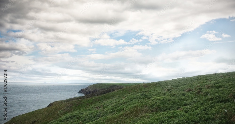 Fototapeta premium Scenic view of hill by sea
