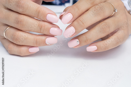 Amazing natural nails. Women's hands with clean manicure. Gel polish applied.