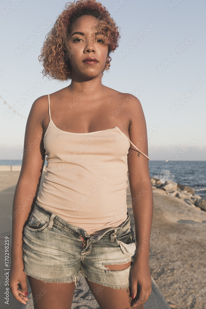 Fototapeta premium African American woman standup in shorts on Beach