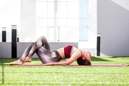 Woman practicing yoga in the park - Healthy lifestyle