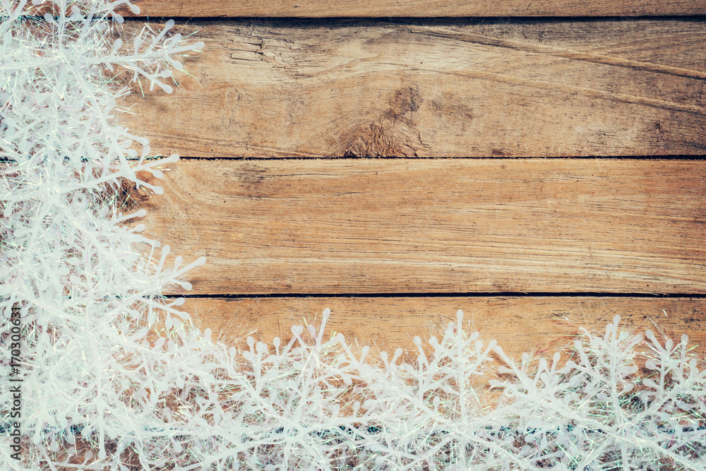 Fototapeta premium Wooden brown christmas background and white snowflakes with space.