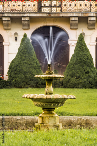 Small fountain in castle park in czech Zahradky. Water show. Czech nature. photo