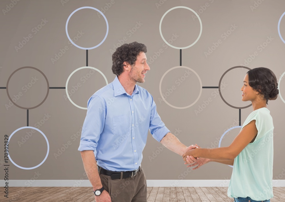 Man and woman shaking hands with mind map Man and woman shaking hands with mind map