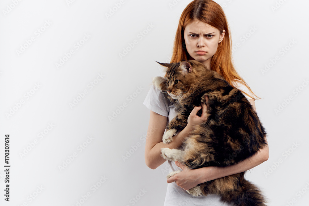 young woman holds a cat, blank space to copy