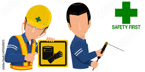 Worker is holding warning sign for the welder
