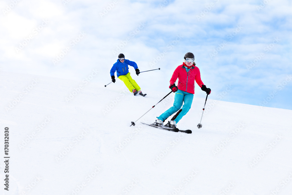 Ski holiday, Two skiers carving downhill, Sudelfeld, Bavaria, Germany Ski holiday, Two skiers carving downhill, Sudelfeld, Bavaria, Germany