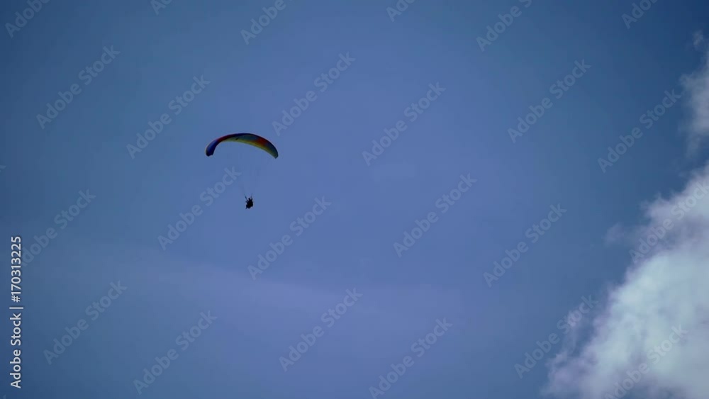 Paraglider flying in the sky at sunny day Paraglider flying in the sky at sunny day