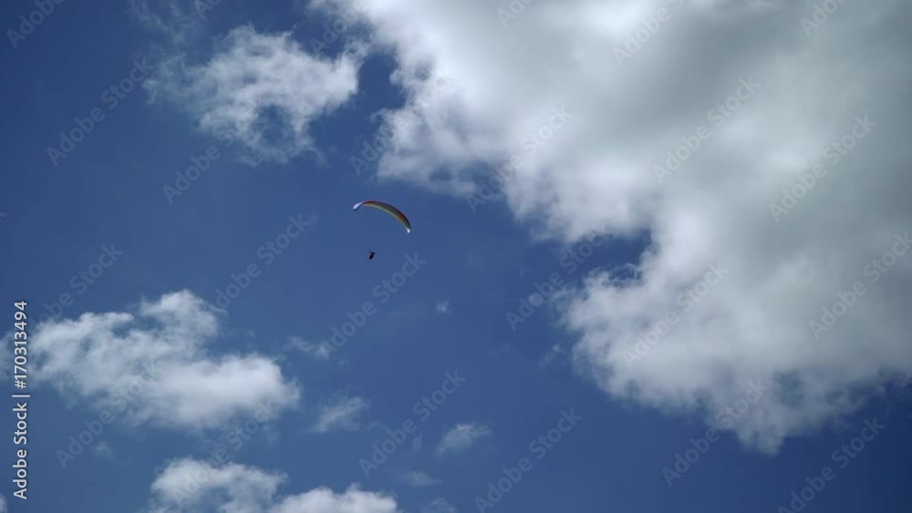 Paraglider flying in the sky at sunny day Paraglider flying in the sky at sunny day