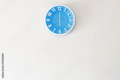 Good morning or evening time with 6:00 clock on white concrete wall interior background with copy space, message board concept. Good morning or evening is the greeting in the morning and evening