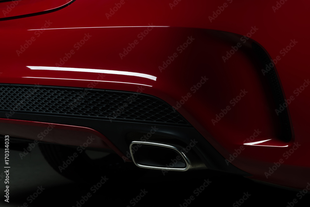 Car detailing series: Closeup of red car exhaust pipe
