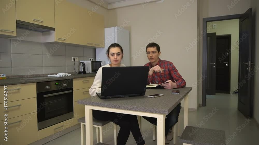 Guy and the girl discuss the project in the kitchen Guy and the girl discuss the project in the kitchen