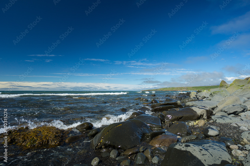 Iceland - Waves of blue ocean at blonduos beach with blue sky and nobody