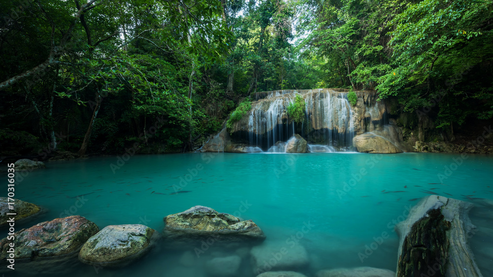 Fototapeta premium Breathtaking green waterfall at deep forest, Erawan waterfall located Kanchanaburi Province, Thailand