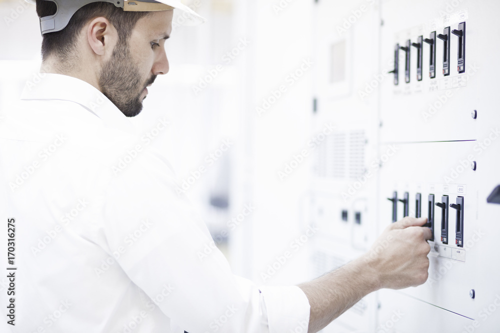 Engineer checking switch in electricity substation Engineer checking switch in electricity substation