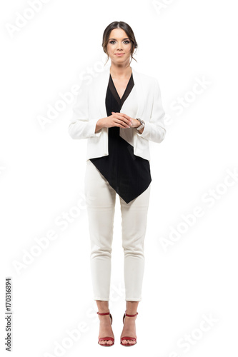 Quadro em tela Friendly smiling business female presenter in formal suit with hands clasped looking at camera