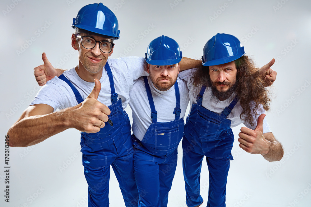 Three funny builders - isolated portrait Three funny builders - isolated portrait