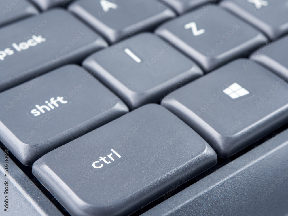 Gray keyboard with focus on Strl and Shift buttons and soft focus on back Gray keyboard with focus on Strl and Shift buttons and soft focus on back
