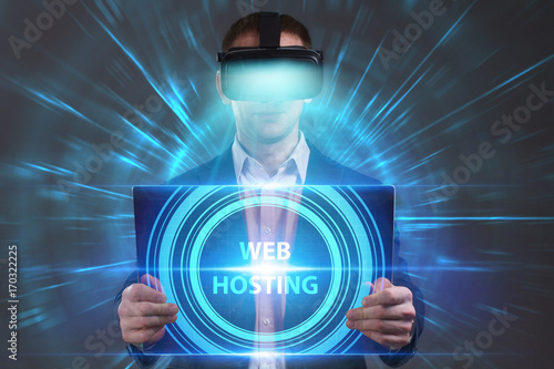 Business, Technology, Internet and network concept. Young businessman working in virtual reality glasses sees the inscription: Web hosting