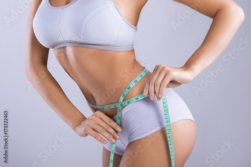 Woman is measuring her waistline