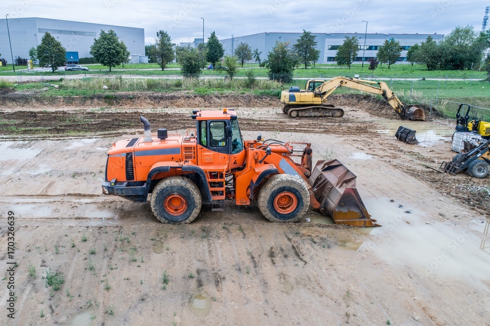 Orange loader bulldozer in the mud