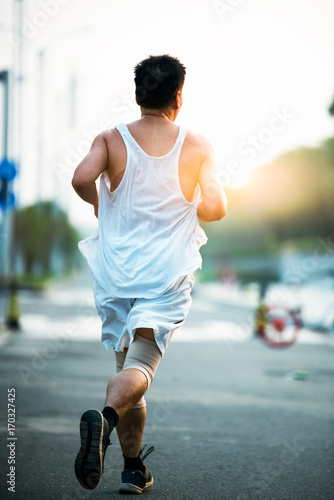 Runner athlete running on road. woman fitness sunrise jogging workout wellness concept.