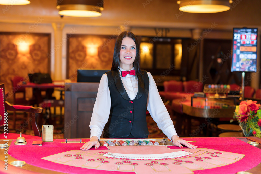 Cute lady casino dealer at poker table. Cute lady casino dealer at poker table.