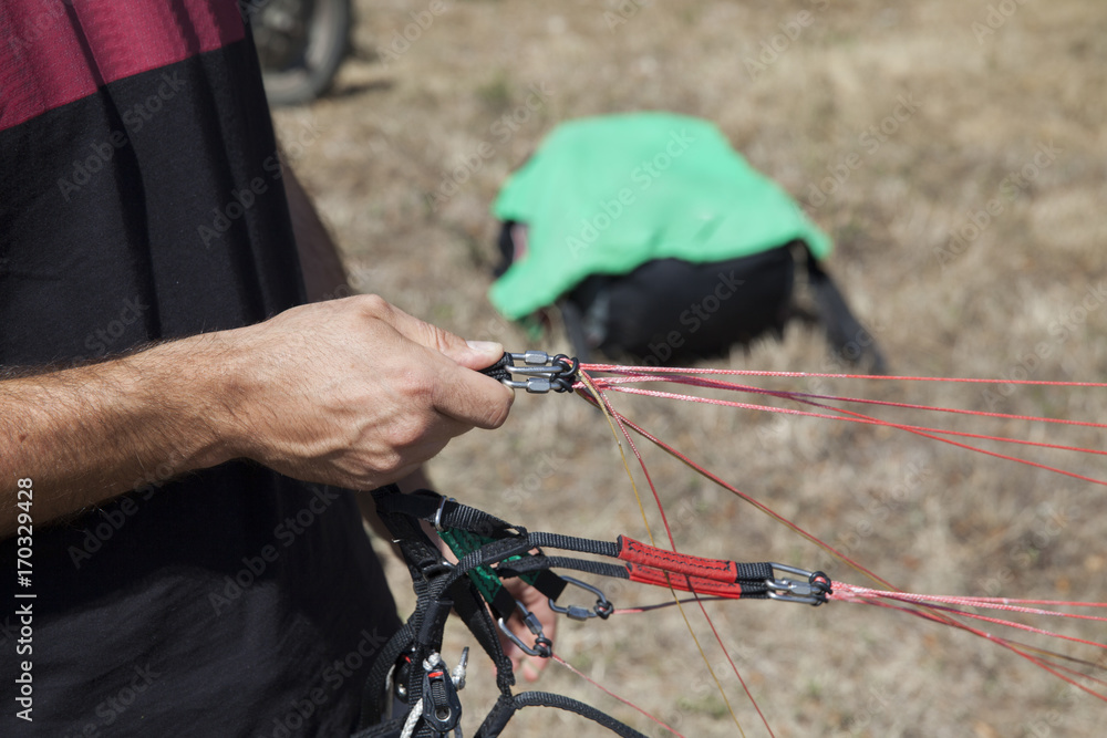 pilot paraglider before take-off..