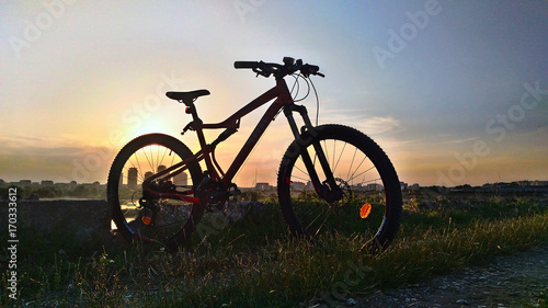 Fototapeta Naklejka Na Ścianę i Meble -  Mountain bike silhouette at sunset