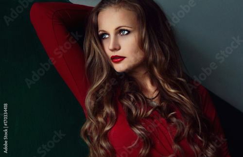 Beauty fashion portrait. Smiling young woman withe red lips on white green wall. curly hair girl 