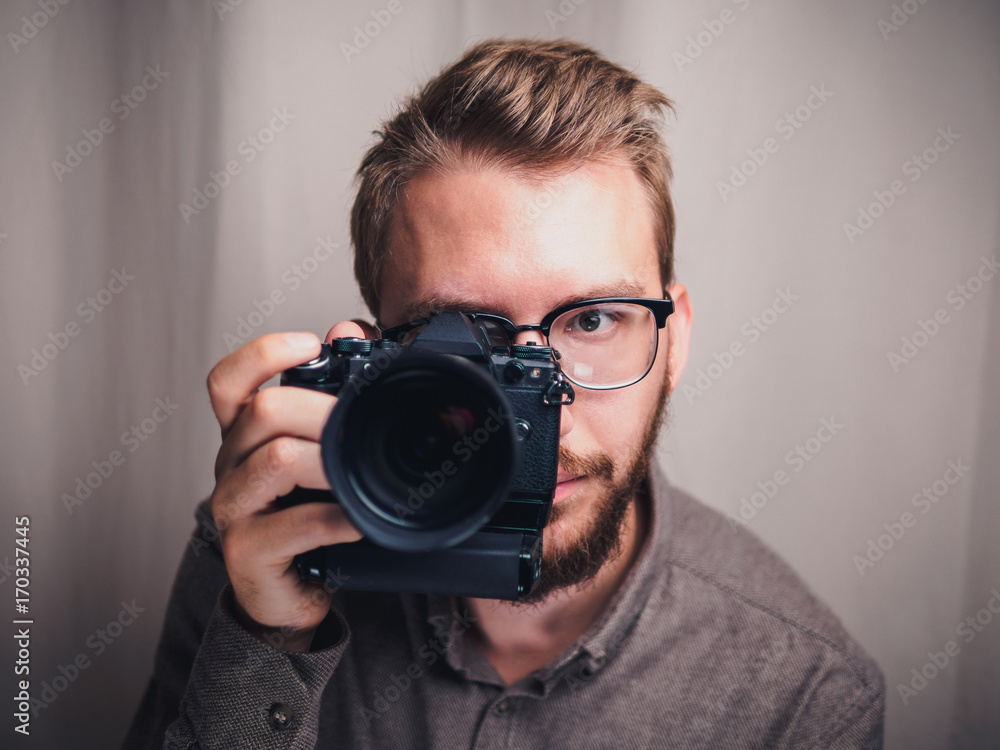Male photographer with camera in arm Male photographer with camera in arm
