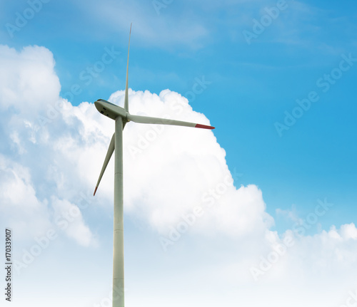 Green renewable energy concept - wind generator turbines in sky photo