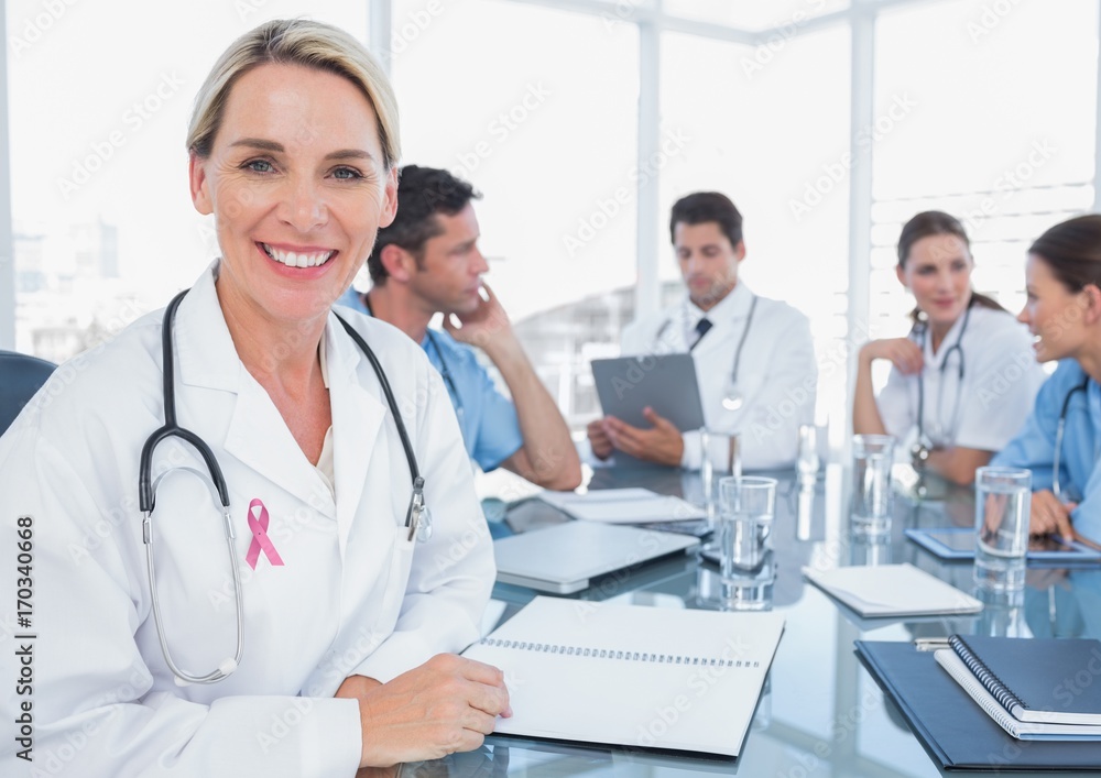 Doctor woman with breast cancer awareness ribbon Doctor woman with breast cancer awareness ribbon