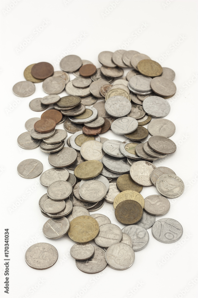 Mixed coins of various countries on a white background Mixed coins of various countries on a white background