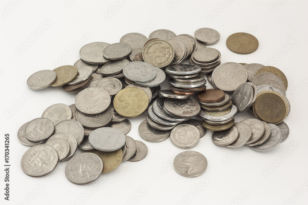 Mixed coins of various countries on a white background Mixed coins of various countries on a white background