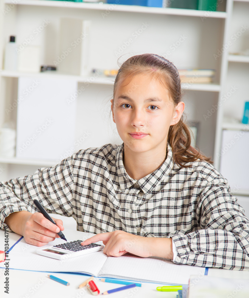 Teenage girl preparing for exams. Teenage girl doing homework for school.. Teenage girl preparing for exams. Teenage girl doing homework for school..