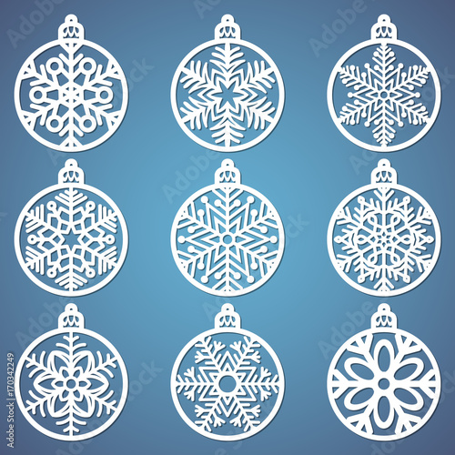 Christmas balls set with a snowflake cut out of paper. Templates for laser cutting, plotter cutting or printing. Festive background.