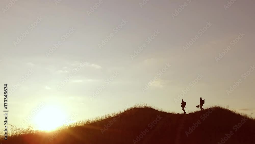 people group of tourists walking on top of a sunset silhouette mountain. slow video tourists people group go travel nature people group of tourists walking on top of a sunset silhouette mountain. slow video tourists people group go travel nature