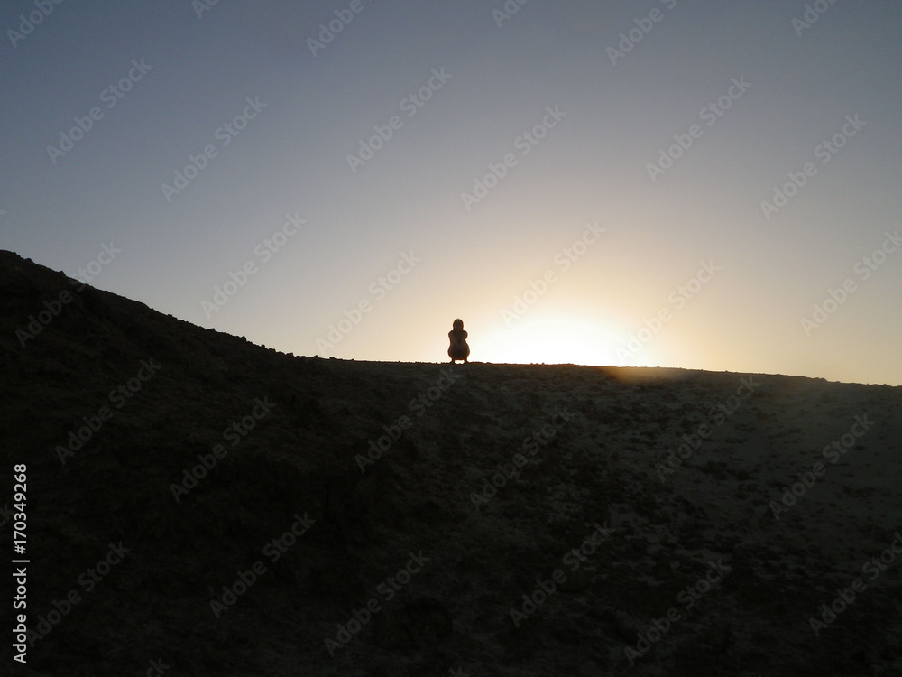 silhouette of a woman on a mountain