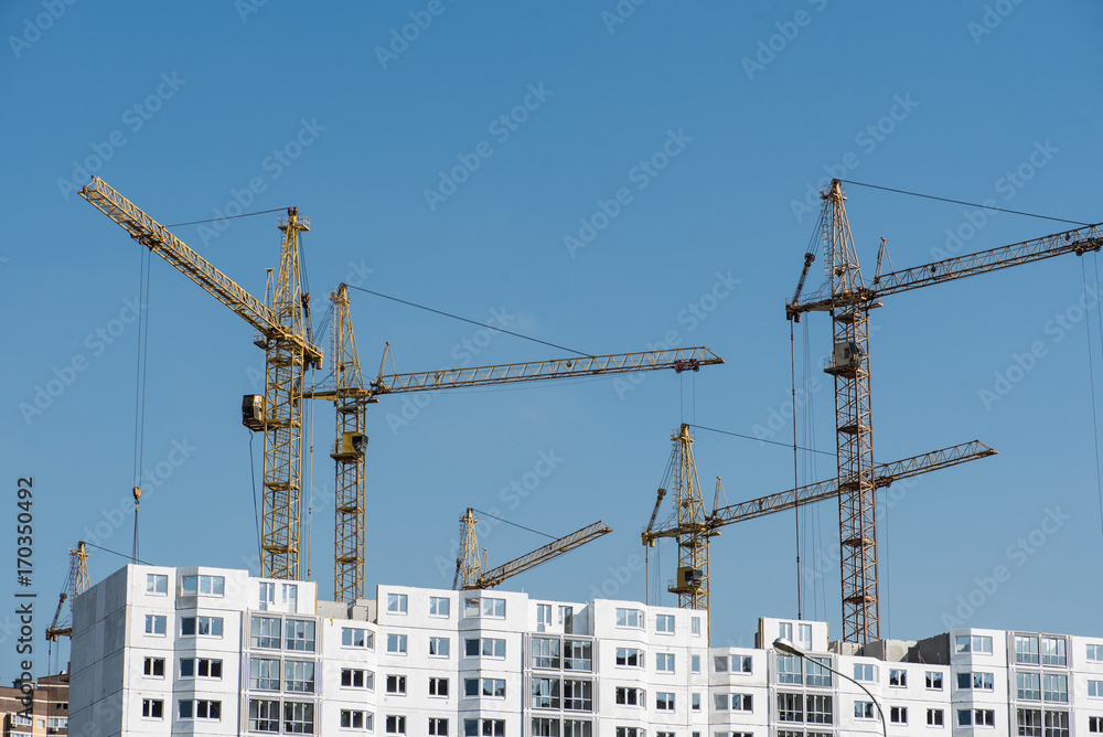 Tower cranes building new houses Tower cranes building new houses