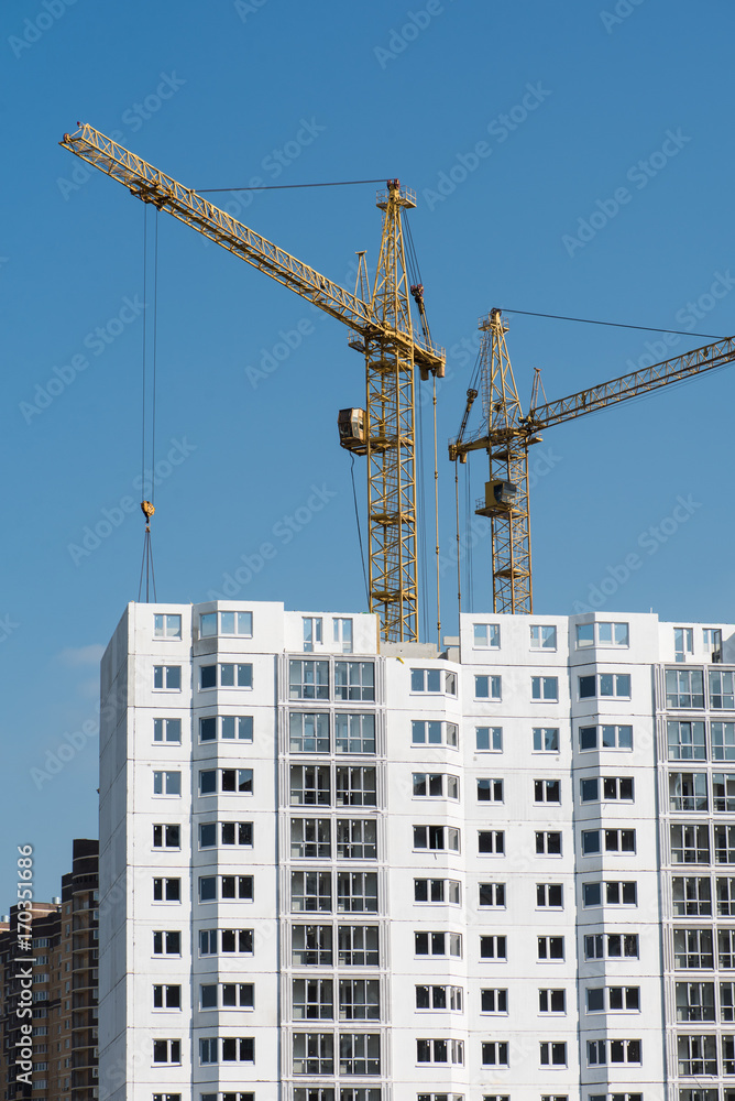 Column cranes at construction site of new high-rise apartment building Column cranes at construction site of new high-rise apartment building