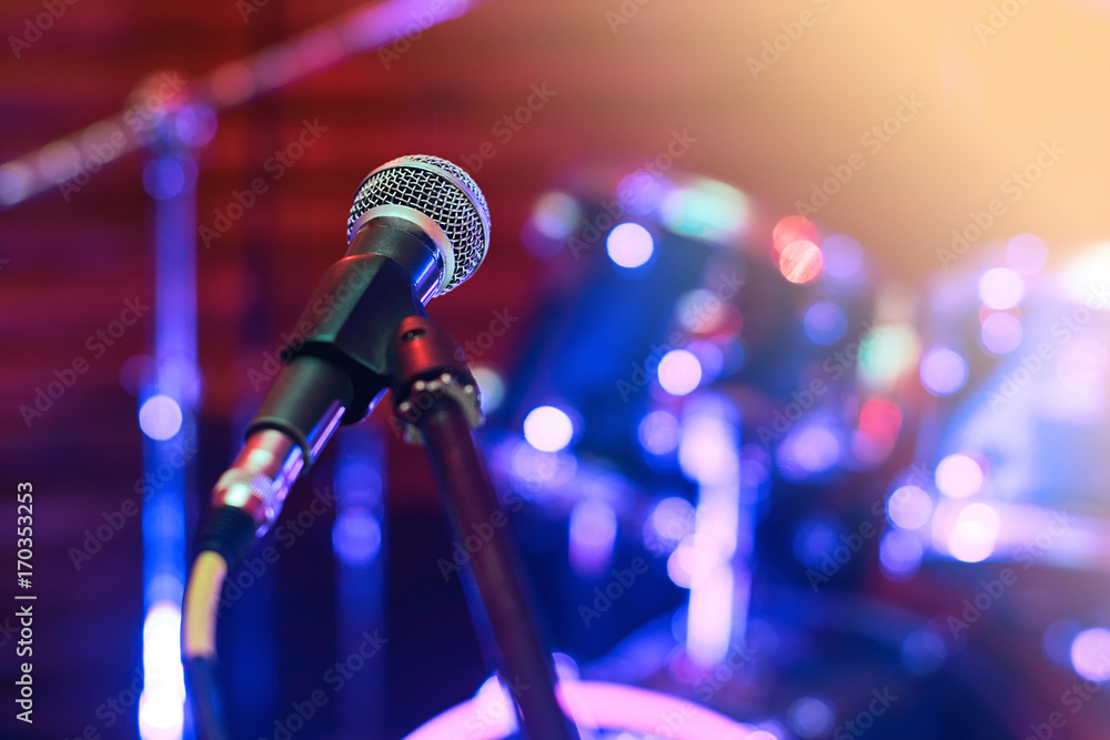 Microphone at concert on the stage with colorful light