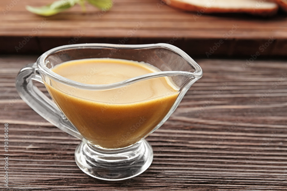 Sauce boat with tasty turkey gravy on table Sauce boat with tasty turkey gravy on table