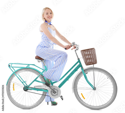 Beautiful young woman riding bicycle on white background © Africa Studio