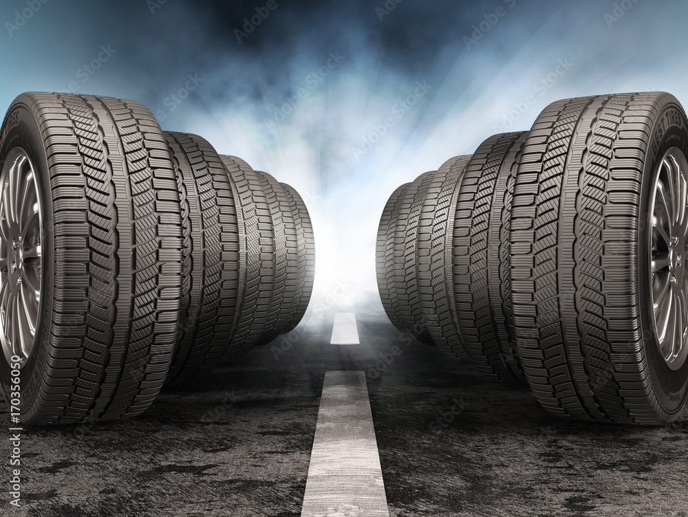 Fototapeta premium Car tires standing on the road against light of headlights.