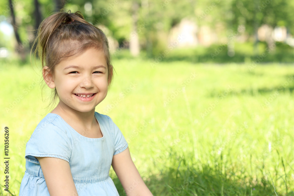 Cute little girl in park on sunny day Cute little girl in park on sunny day