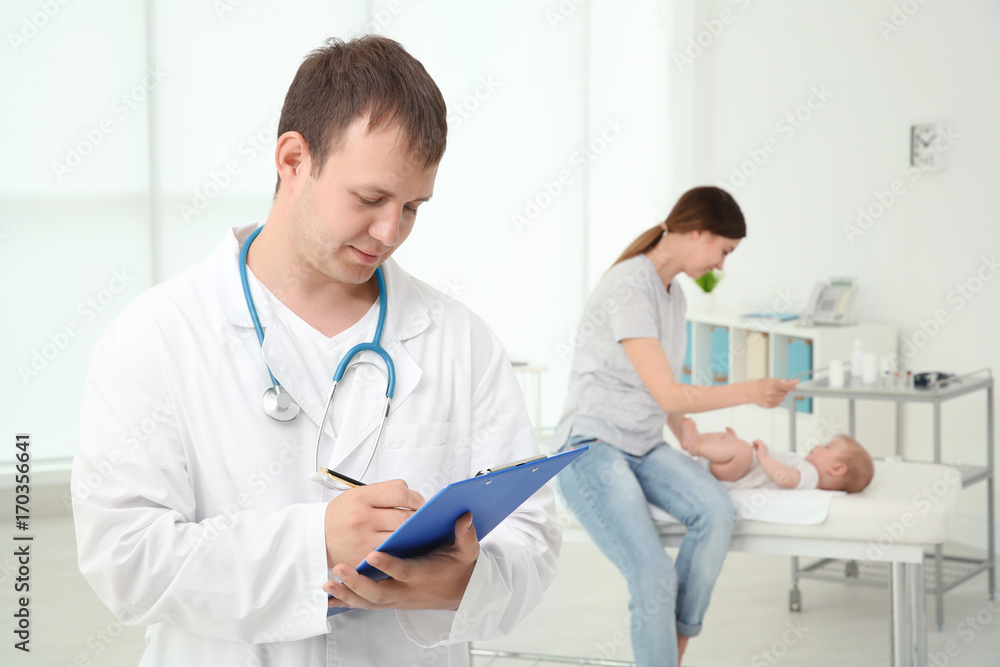 Portrait of family doctor and happy mother with healthy baby in hospital Portrait of family doctor and happy mother with healthy baby in hospital