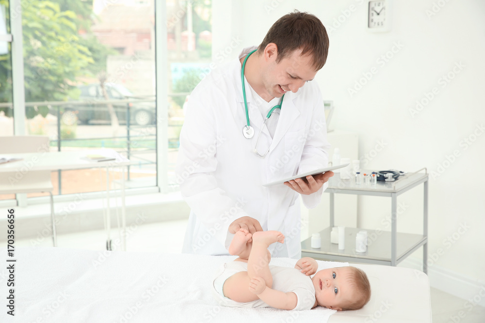 Doctor using tablet and baby in hospital Doctor using tablet and baby in hospital
