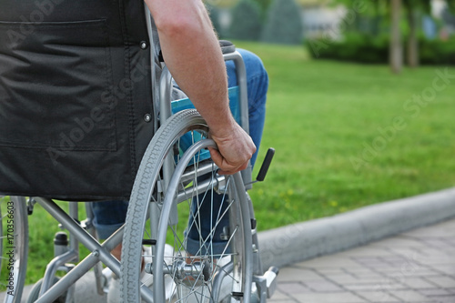 Elderly man in wheelchair outdoors