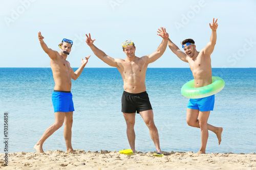 Handsome young men on sea beach